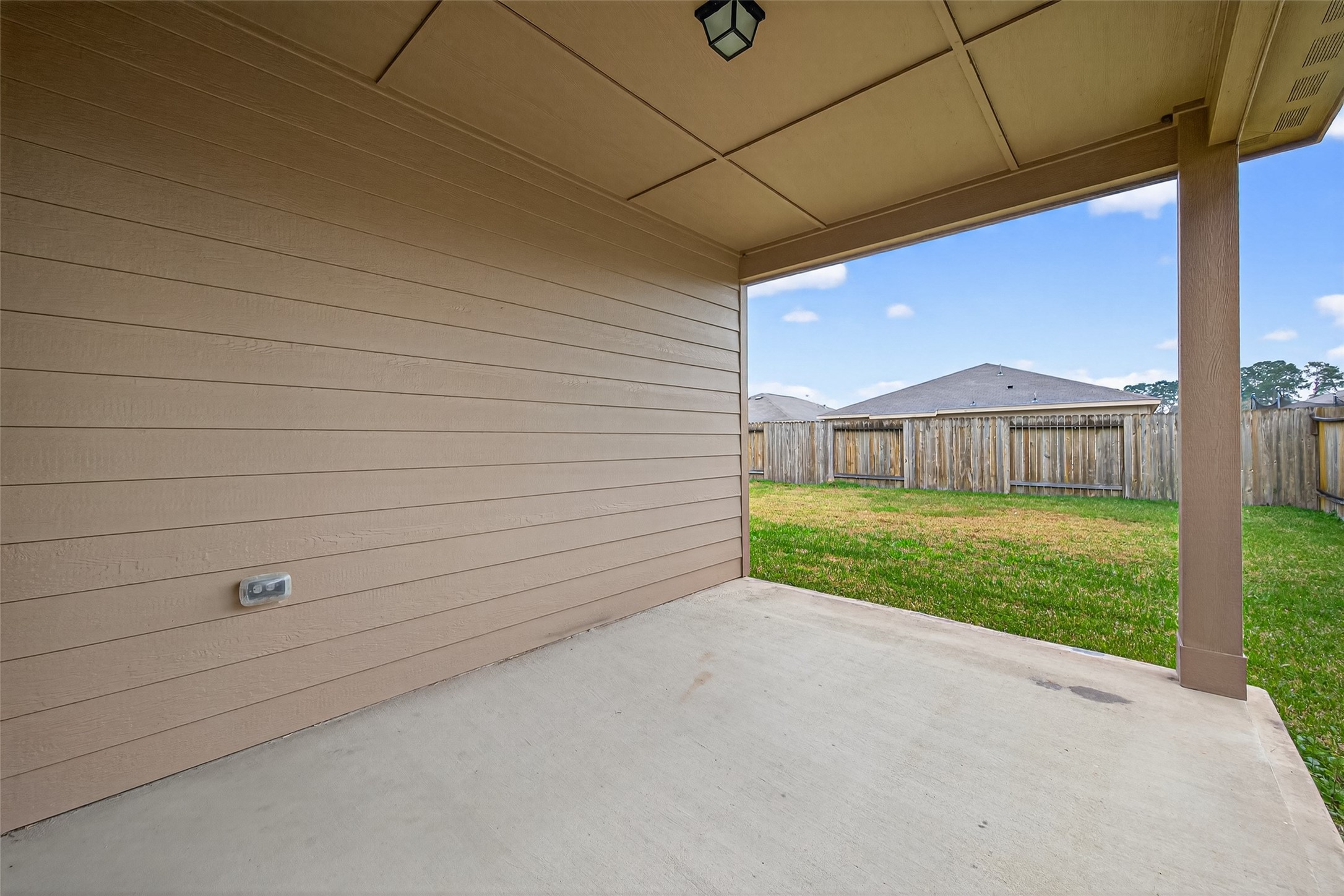 12038 Powderhorn Lane Pinehurst, TX 77362 - Photo 40 of 50 a view of a house with a backyard and a garage