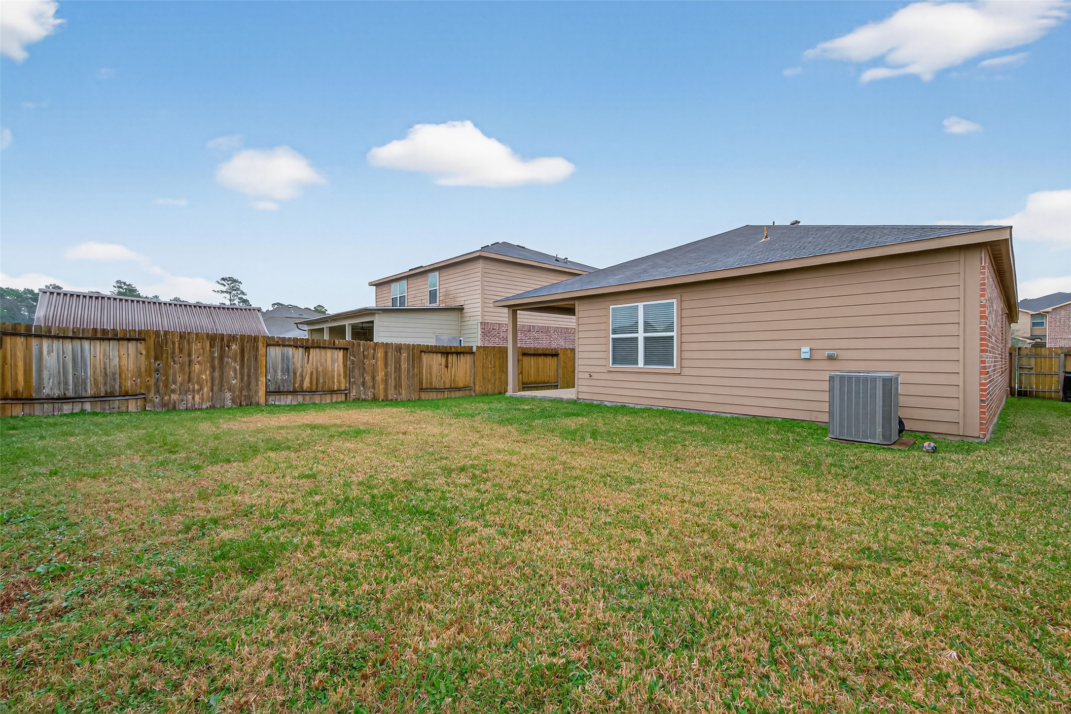 12038 Powderhorn Lane Pinehurst, TX 77362 - Photo 45 of 50 a view of a house with a backyard