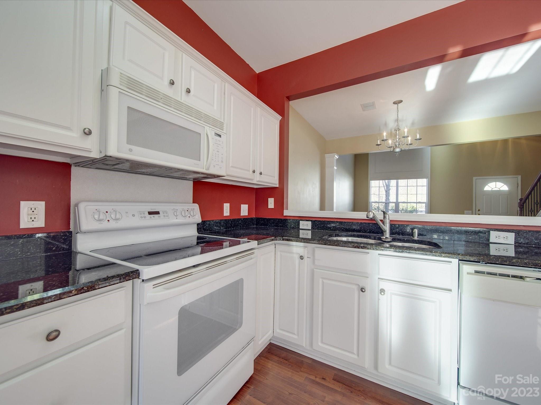 11755 Huxley Road Charlotte, NC 28277 - Photo 13 of 37 a kitchen with granite countertop a sink stainless steel appliances and cabinets