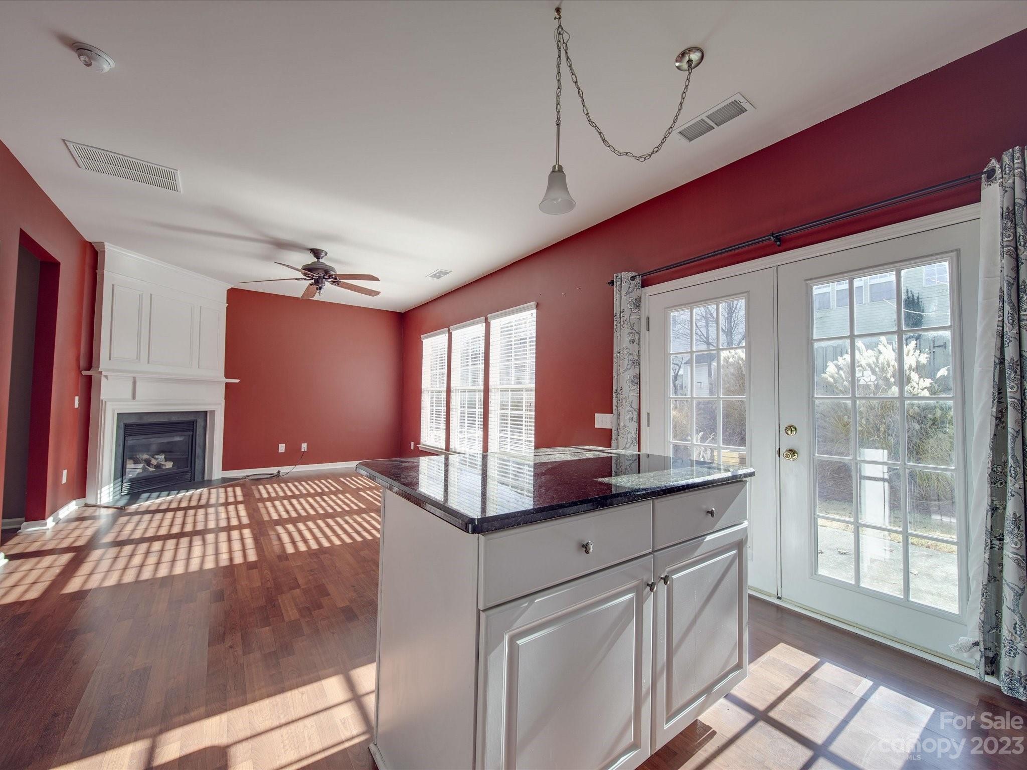 11755 Huxley Road Charlotte, NC 28277 - Photo 14 of 37 a view of a kitchen with kitchen island granite countertop a large window cabinets and stainless steel appliances