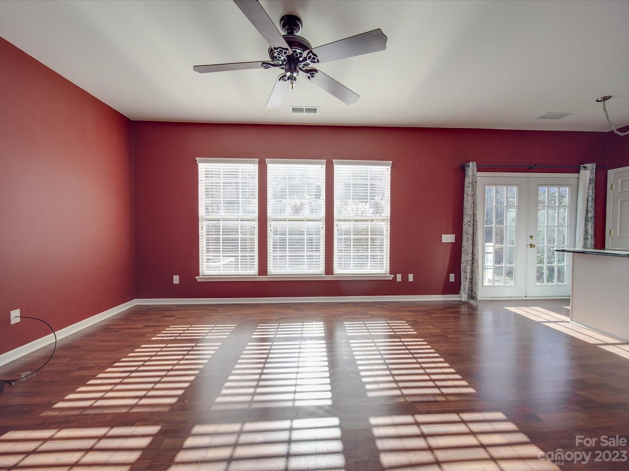 11755 Huxley Road Charlotte, NC 28277 - Photo 15 of 37 a view of an empty room with window and wooden floor