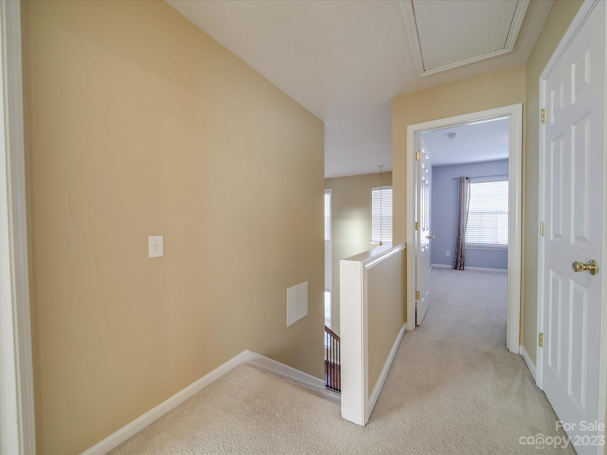 11755 Huxley Road Charlotte, NC 28277 - Photo 17 of 37 a view of a hallway with wooden cabinets