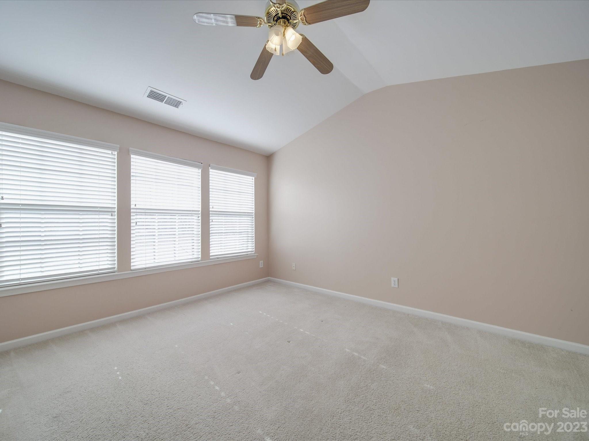 11755 Huxley Road Charlotte, NC 28277 - Photo 23 of 37 an empty room with a window and a ceiling fan