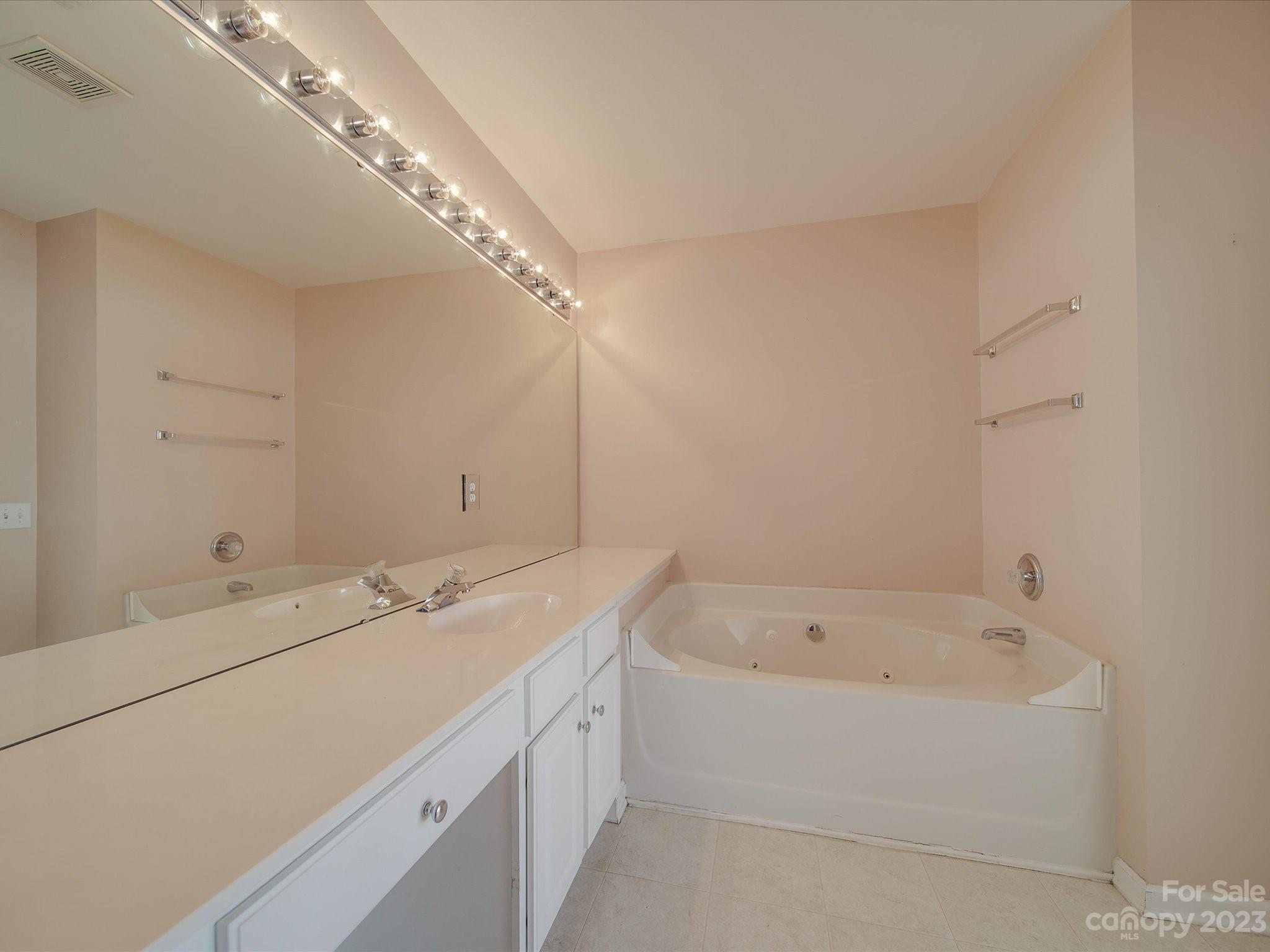 11755 Huxley Road Charlotte, NC 28277 - Photo 26 of 37 a bathroom with a bathtub and a sink