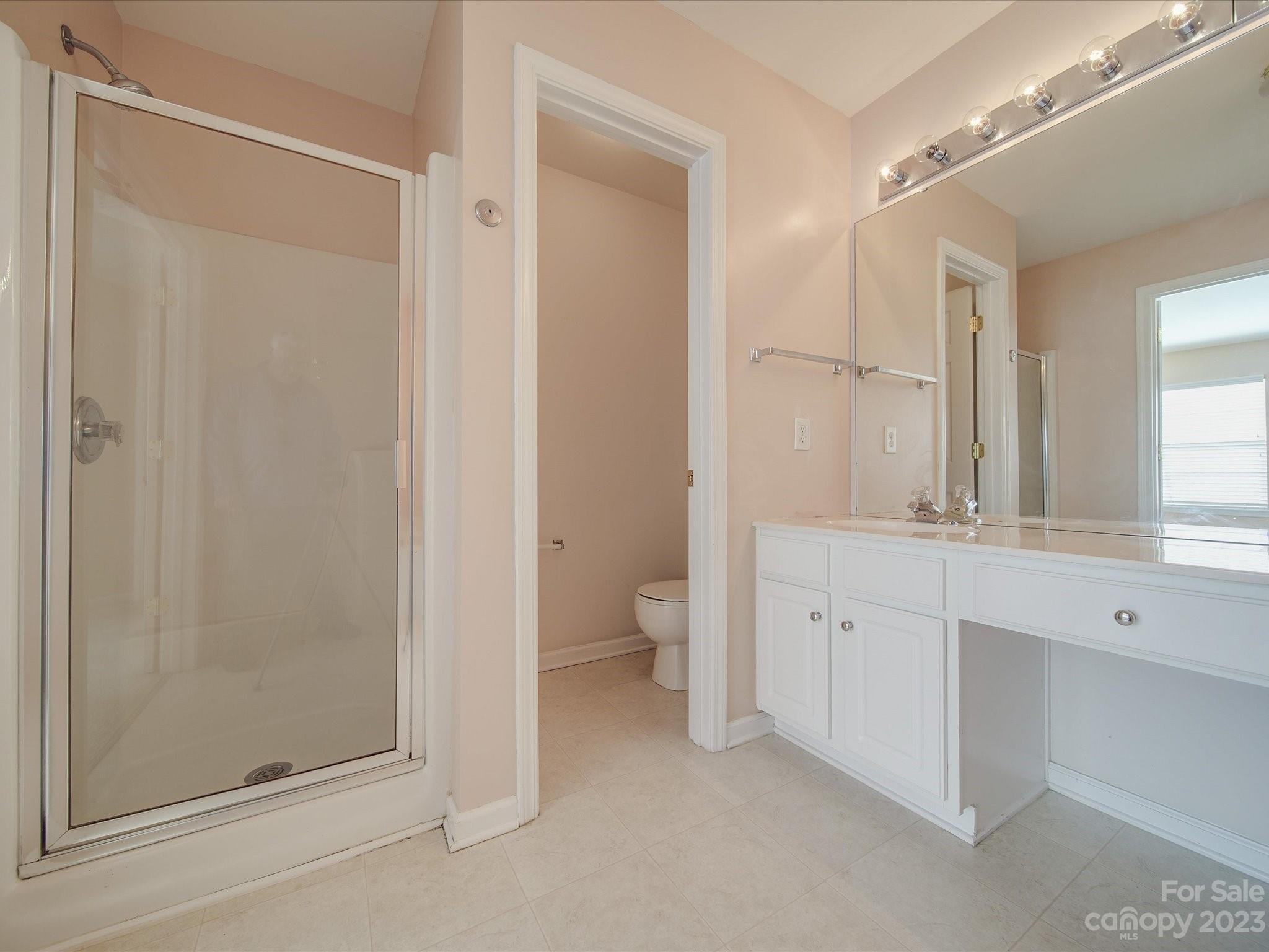 11755 Huxley Road Charlotte, NC 28277 - Photo 27 of 37 a bathroom with a granite countertop sink mirror and toilet