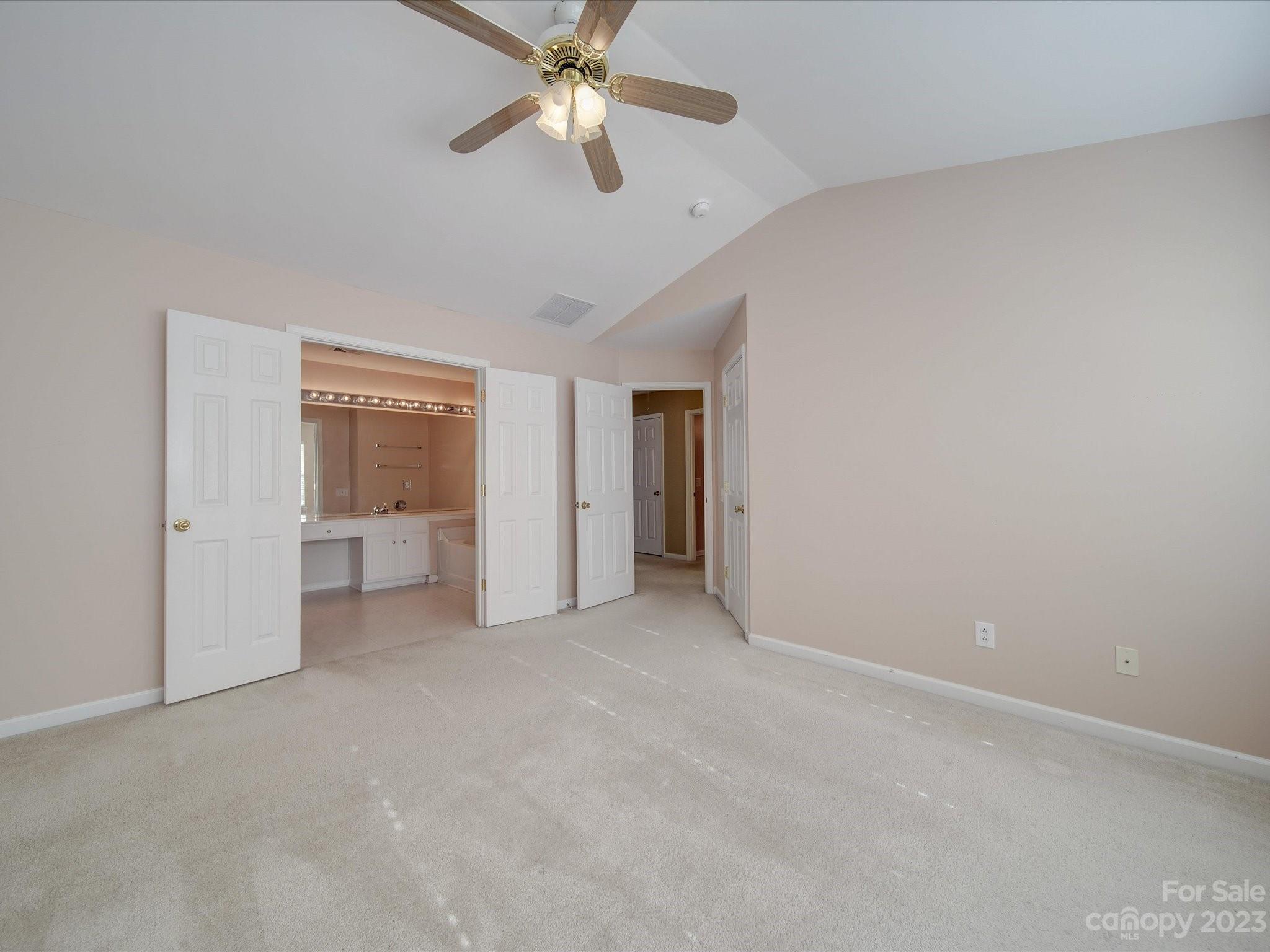 11755 Huxley Road Charlotte, NC 28277 - Photo 28 of 37 an empty room with closet and a ceiling fan