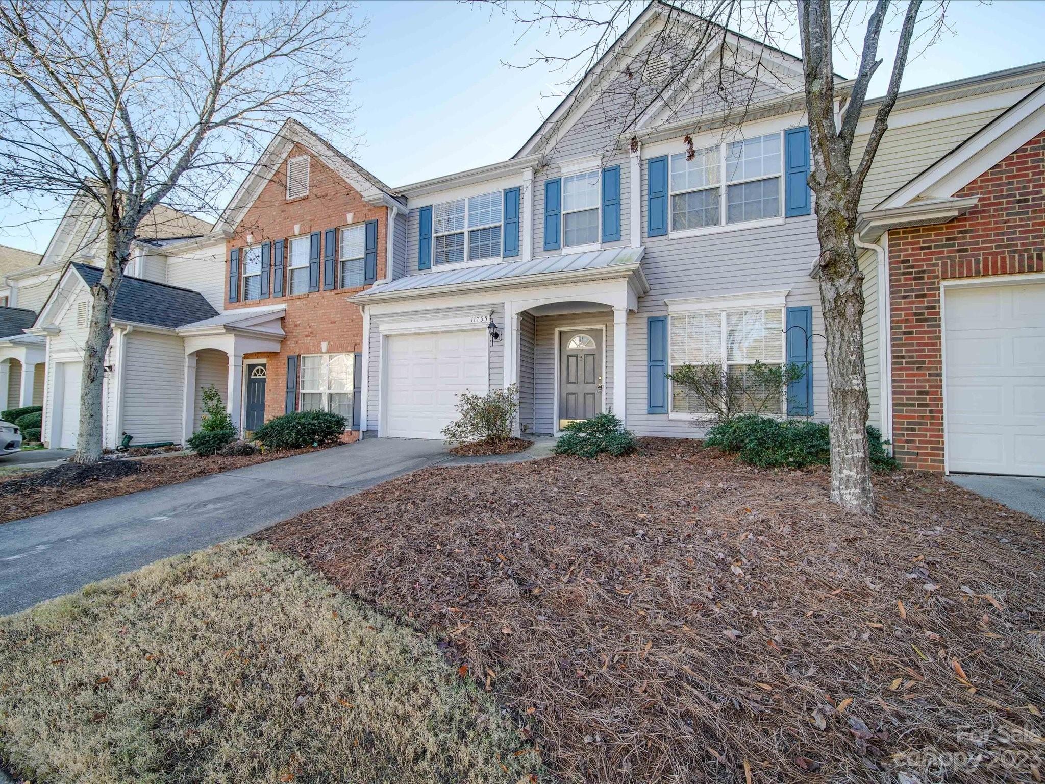 11755 Huxley Road Charlotte, NC 28277 - Photo 4 of 37 a view of a yard in front of a brick house