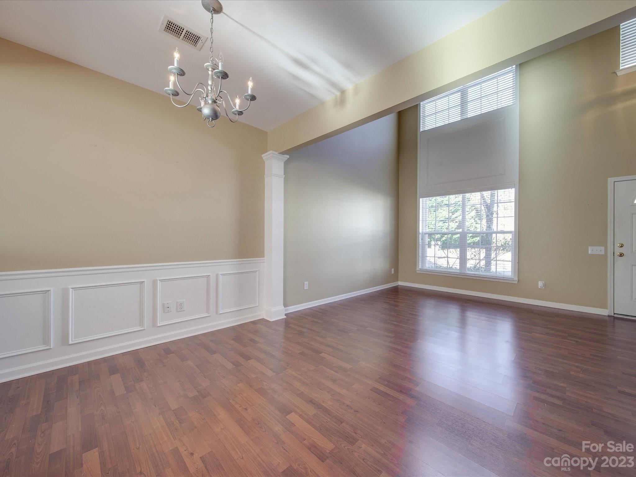 11755 Huxley Road Charlotte, NC 28277 - Photo 8 of 37 a view of an empty room with wooden floor and a window