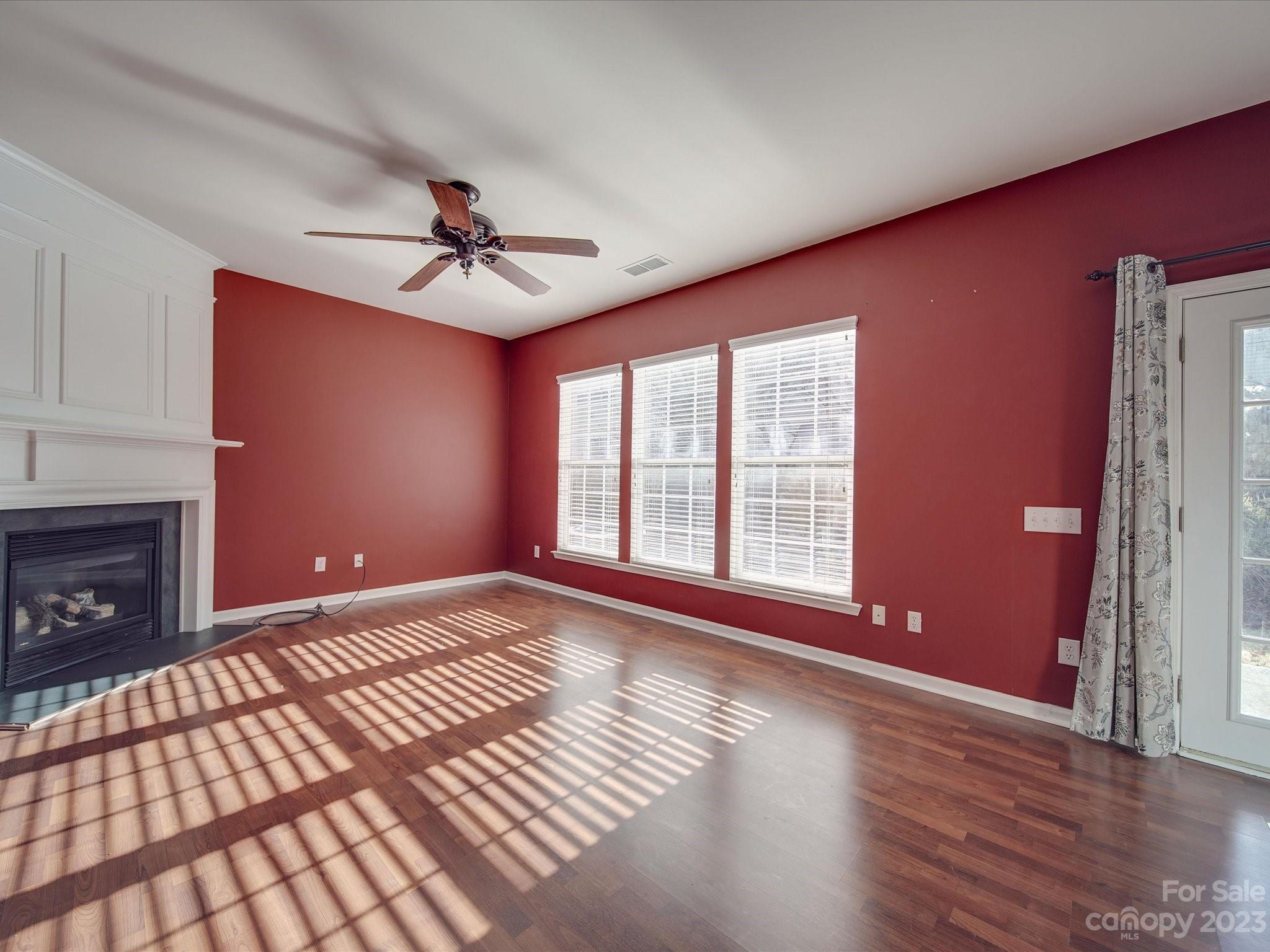 11755 Huxley Road Charlotte, NC 28277 - Photo 9 of 37 a view of an empty room with window and wooden floor