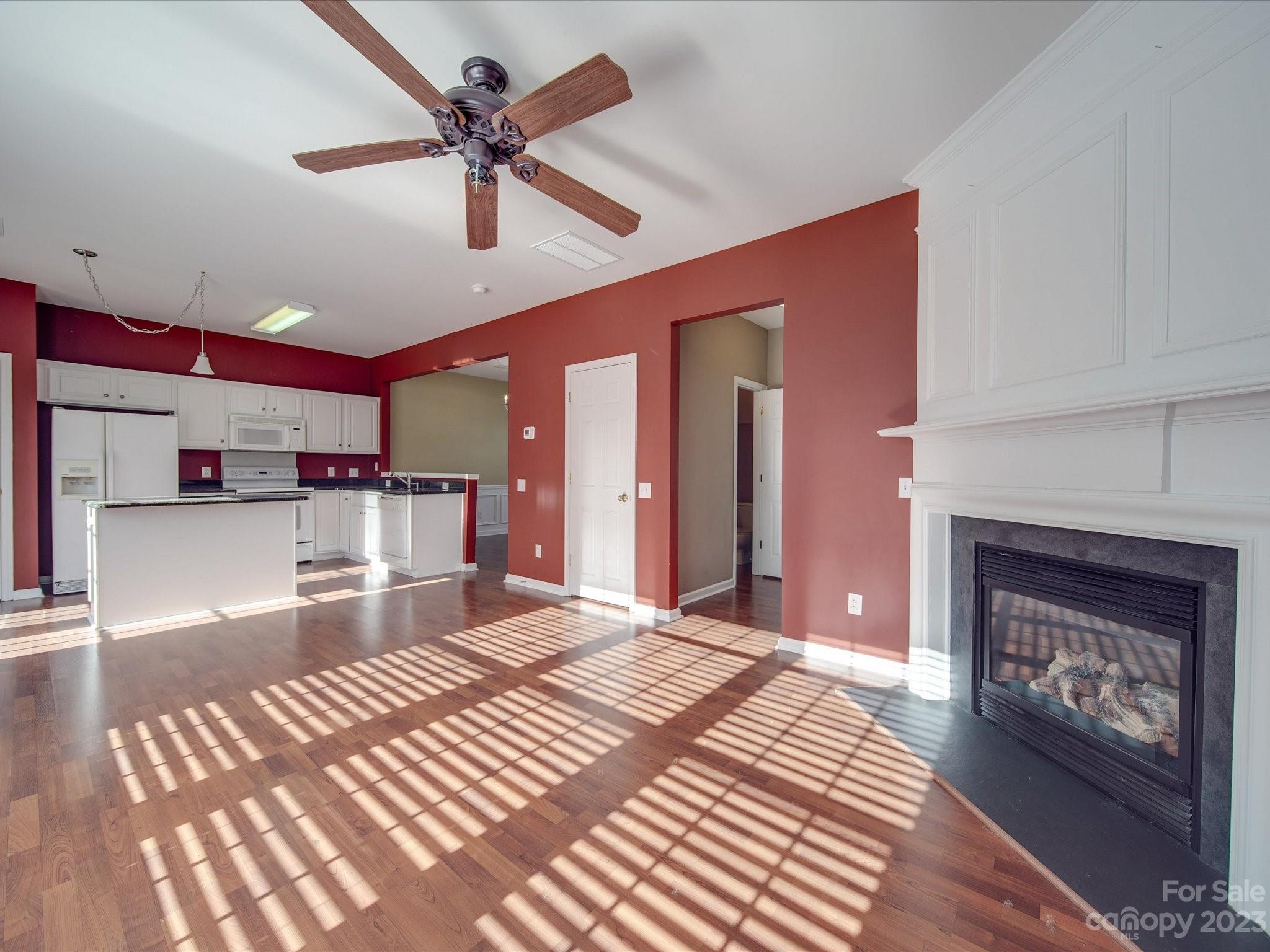 11755 Huxley Road Charlotte, NC 28277 - Photo 10 of 37 a living room with stainless steel appliances kitchen island granite countertop furniture and a fireplace