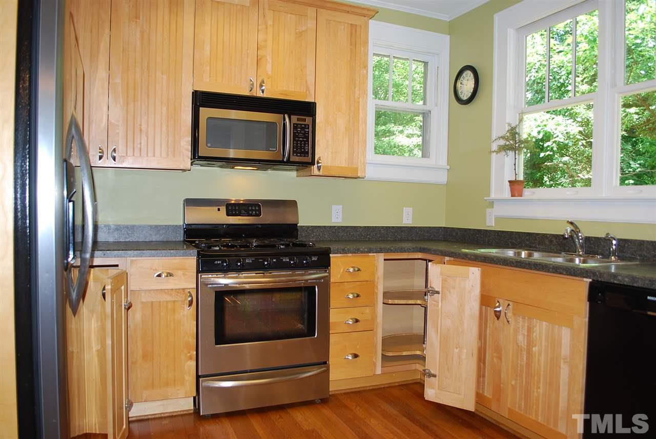 2274 The Circle Raleigh, NC 27608 - Photo 12 of 25 a kitchen with granite countertop a stove a sink and a microwave