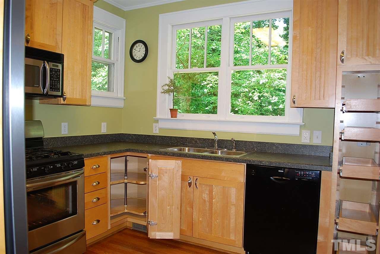 2274 The Circle Raleigh, NC 27608 - Photo 13 of 25 a kitchen with granite countertop a stove a sink and a microwave