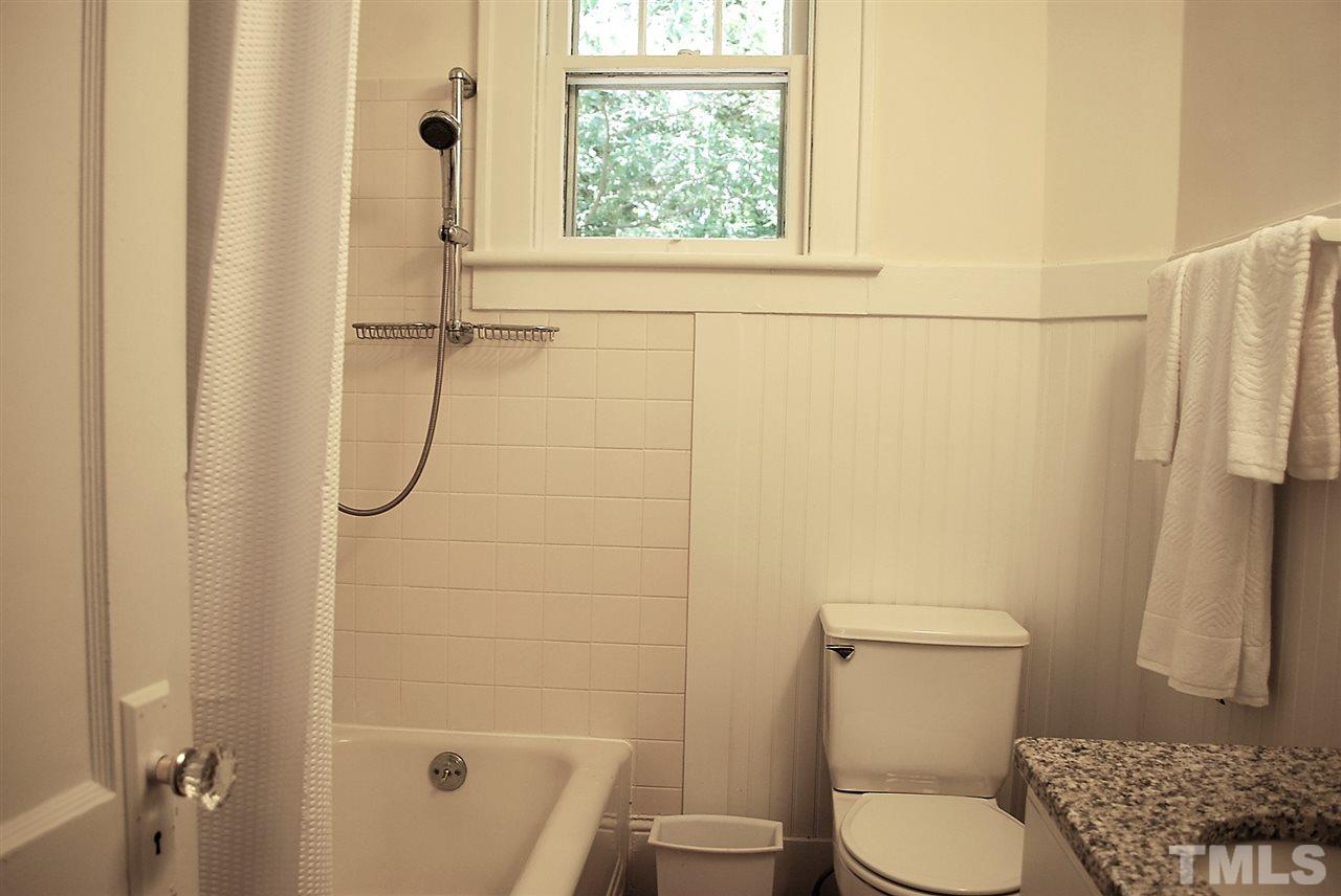 2274 The Circle Raleigh, NC 27608 - Photo 15 of 25 a white toilet sitting next to a bath tub shower