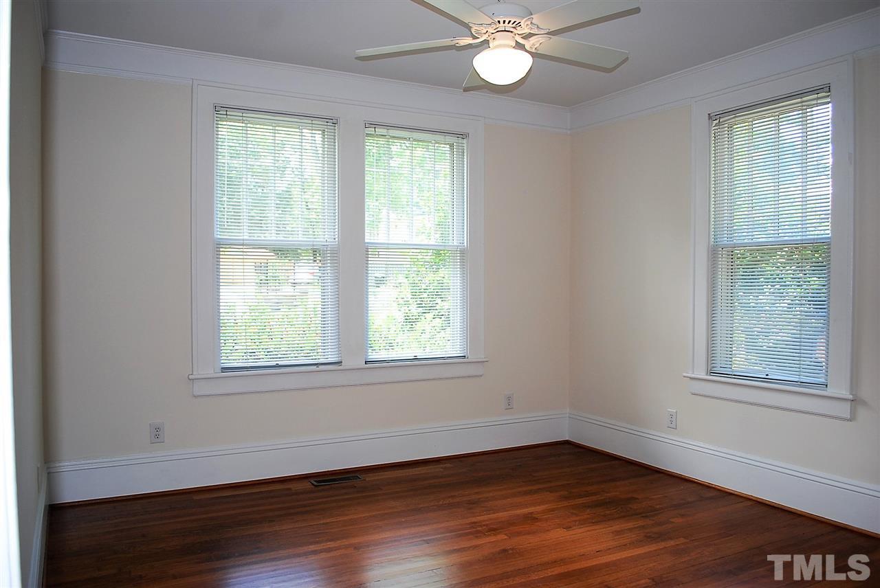2274 The Circle Raleigh, NC 27608 - Photo 17 of 25 an empty room with wooden floor and windows