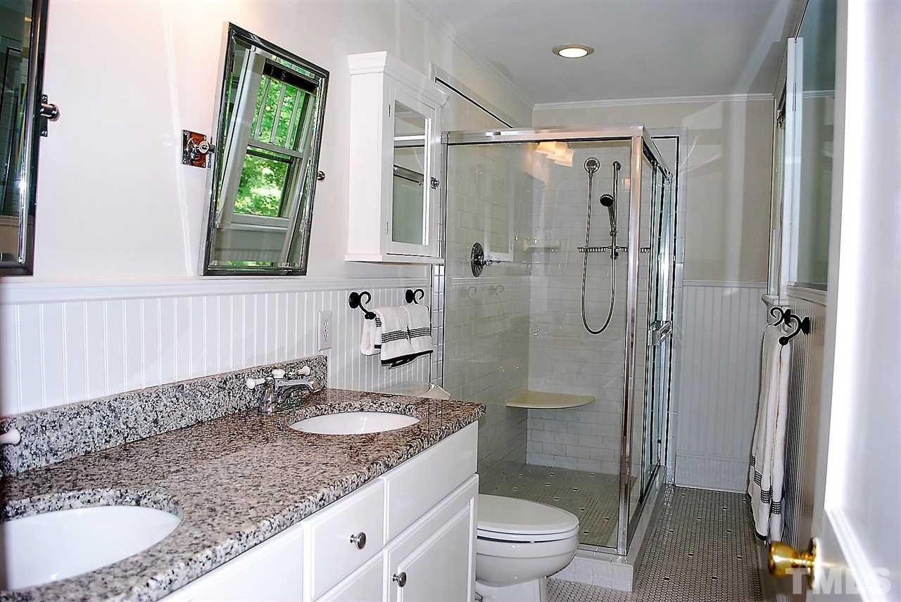 2274 The Circle Raleigh, NC 27608 - Photo 20 of 25 a bathroom with a granite countertop sink toilet and shower