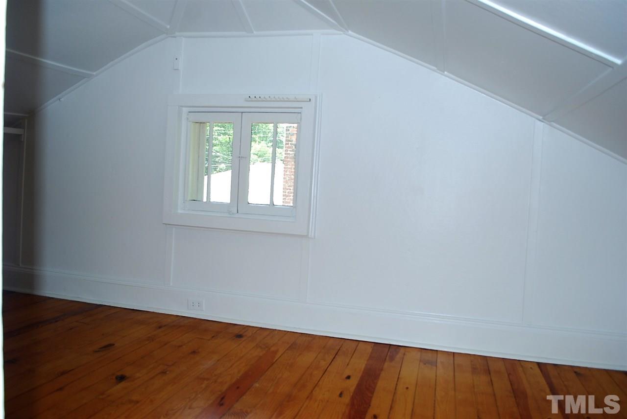 2274 The Circle Raleigh, NC 27608 - Photo 21 of 25 an empty room with wooden floor and windows