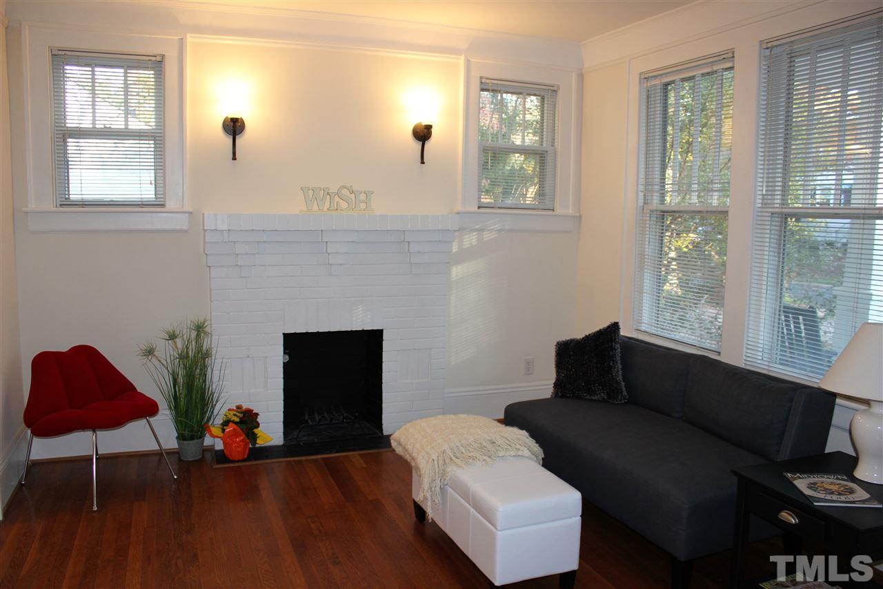2274 The Circle Raleigh, NC 27608 - Photo 3 of 25 a living room with furniture and a fireplace