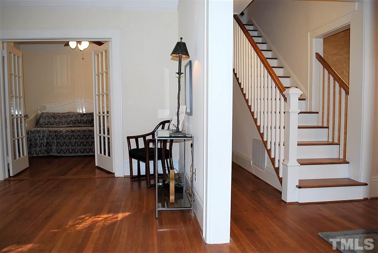 2274 The Circle Raleigh, NC 27608 - Photo 5 of 25 a view of a hallway with wooden floor and stairs