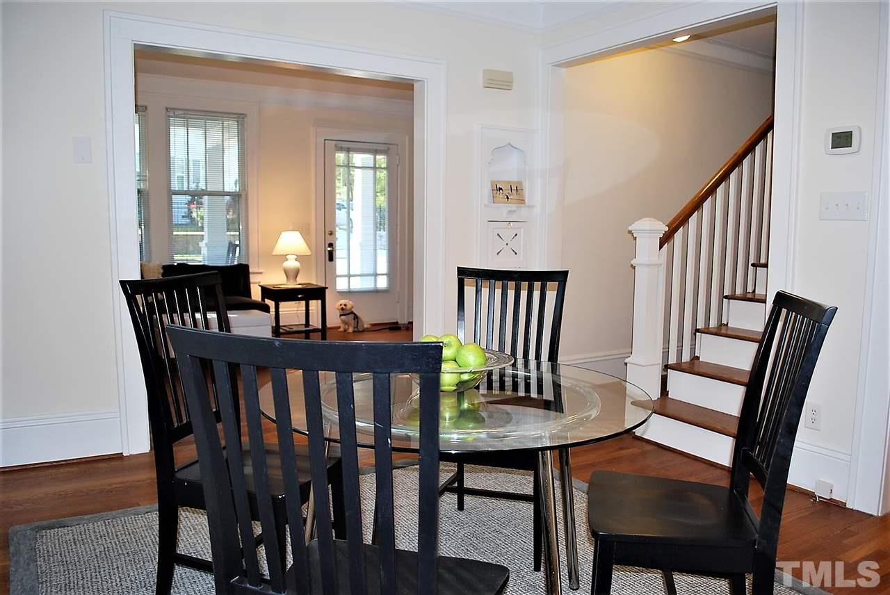 2274 The Circle Raleigh, NC 27608 - Photo 7 of 25 a view of a dining room with furniture and wooden floor