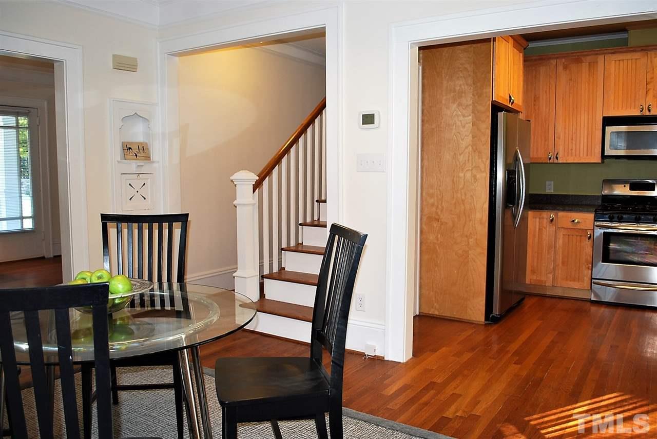 2274 The Circle Raleigh, NC 27608 - Photo 9 of 25 a view of a dining room with furniture and wooden floor