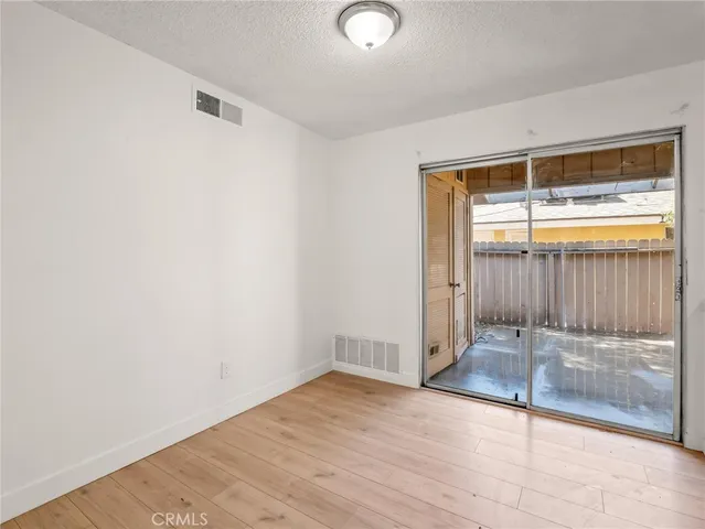 a view of a house with a wooden fence
