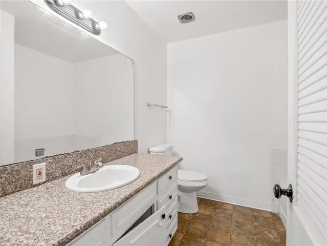 a white bath tub sitting next to a white wooden cabinet
