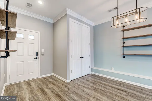 a view of empty room with wooden floor