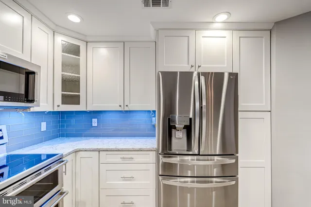 a kitchen with appliances and cabinets