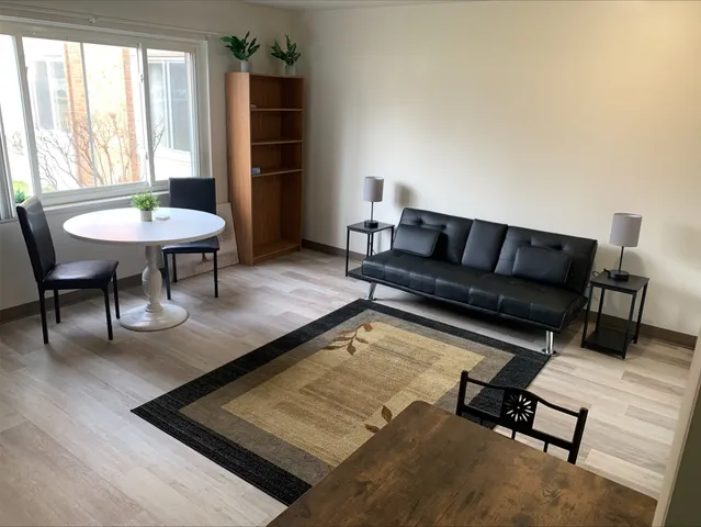 a living room with furniture and a rug