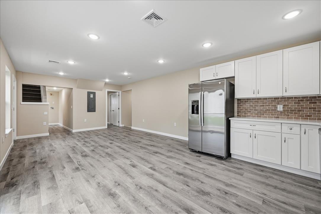 5641 North Coplay Road Whitehall, PA 18052 - Photo 10 of 68 A contemporary lower-level space features sleek vinyl plank flooring and recessed lighting, ready for customization.