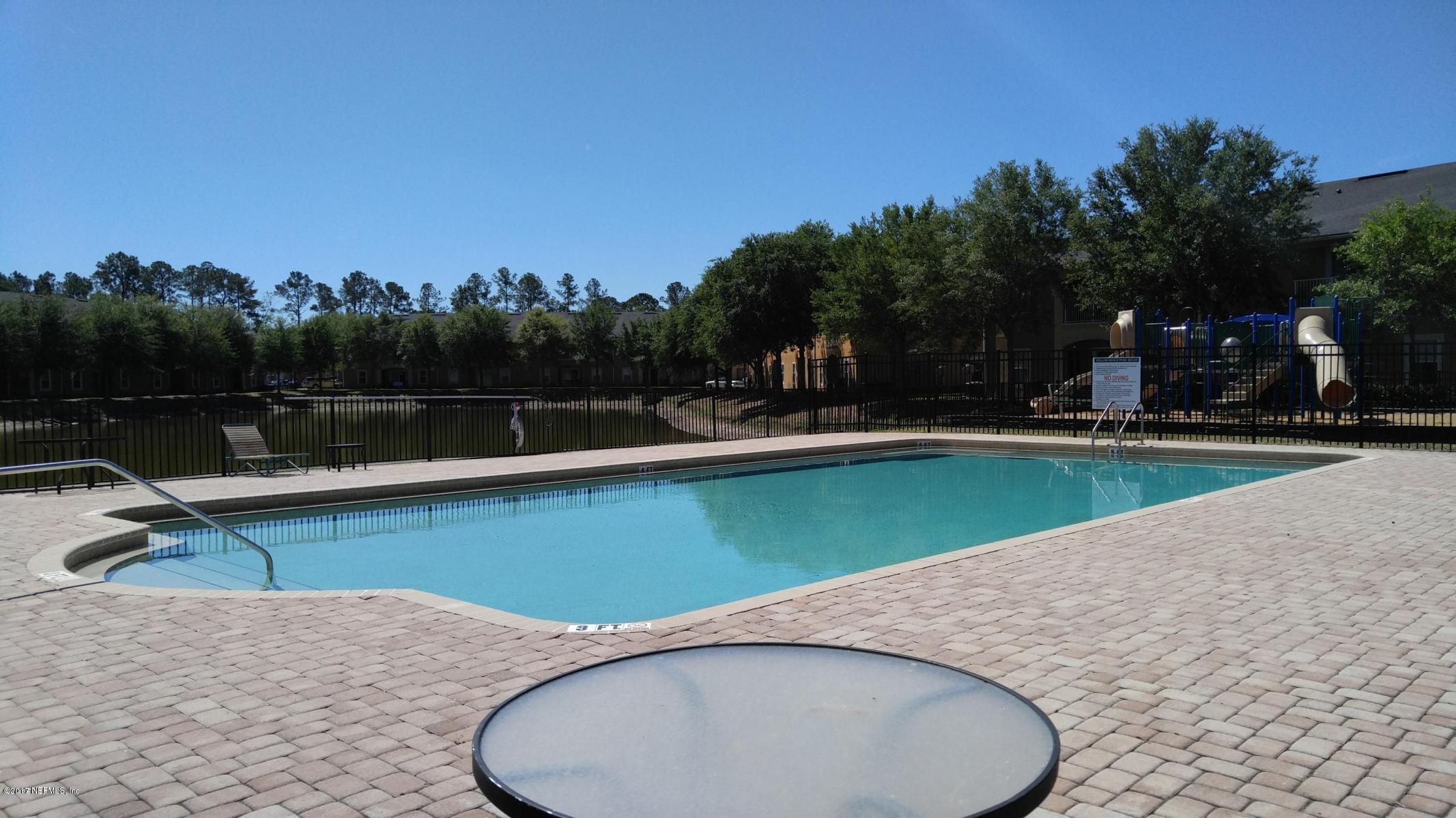 3680 Kirkpatrick Circle, Unit 5 Jacksonville, FL 32210 - Photo 17 of 18 a view of outdoor space with swimming pool and seating