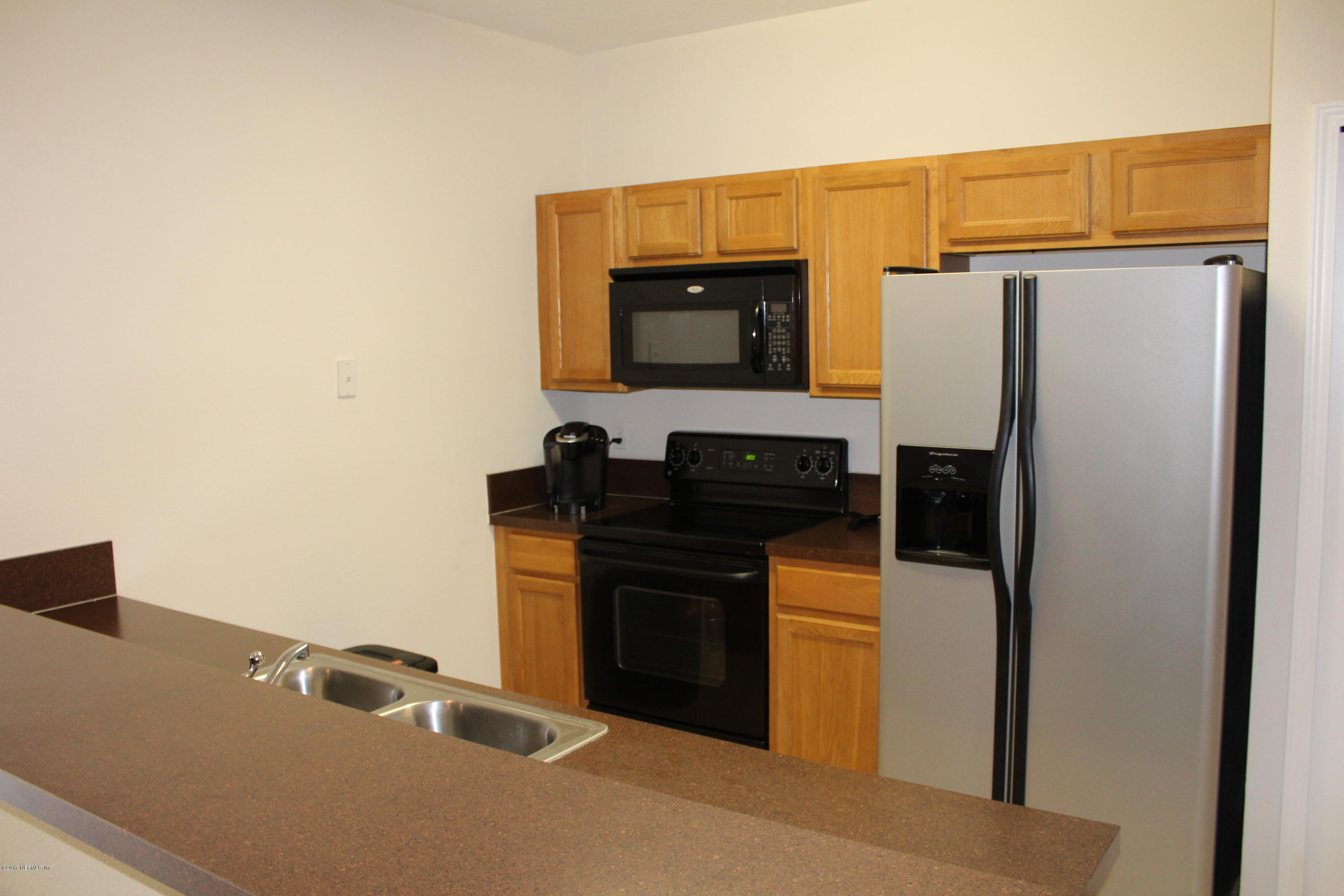 3680 Kirkpatrick Circle, Unit 5 Jacksonville, FL 32210 - Photo 4 of 18 a kitchen with stainless steel appliances a refrigerator and a stove