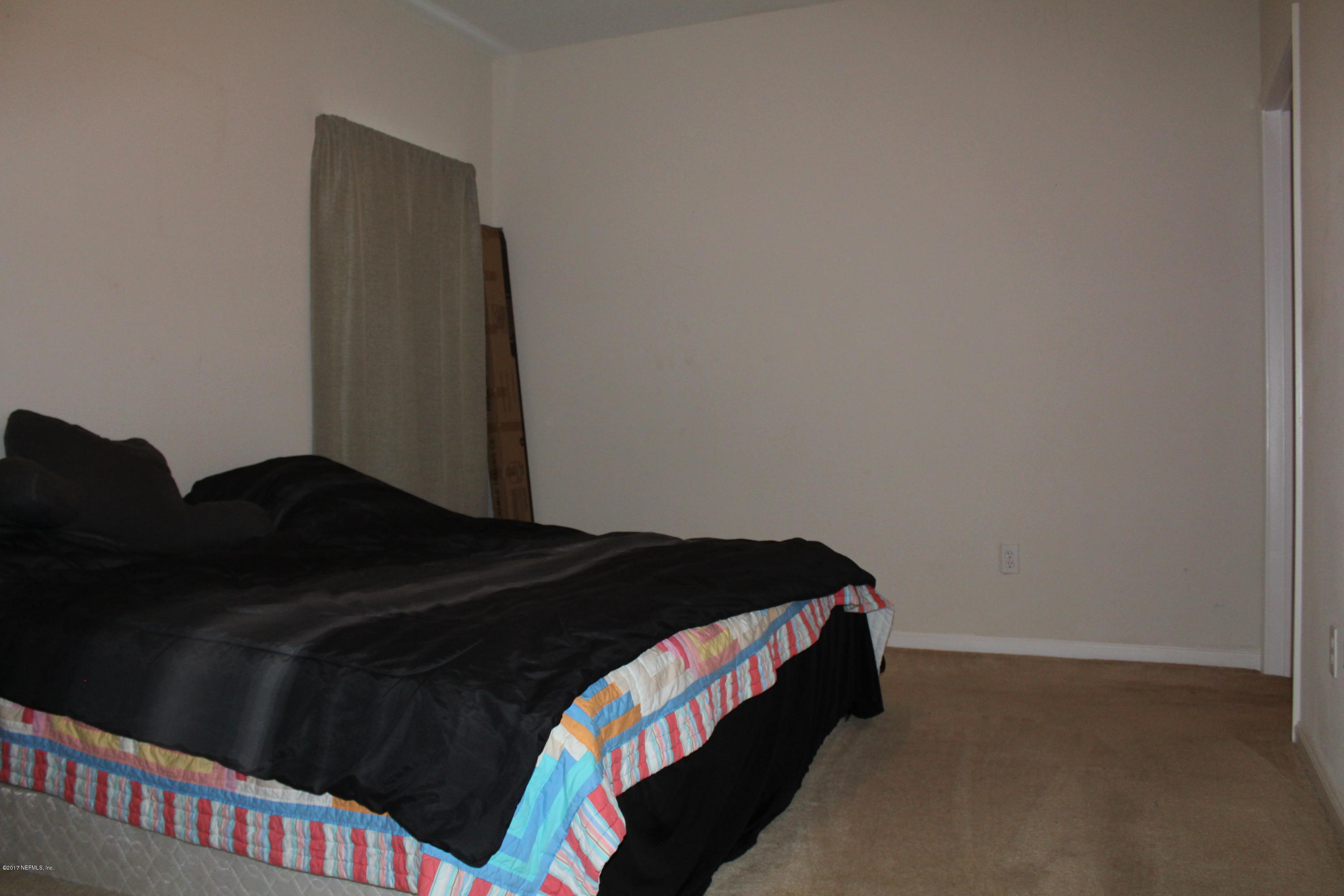 3680 Kirkpatrick Circle, Unit 5 Jacksonville, FL 32210 - Photo 7 of 18 a bedroom with a bed and a dresser