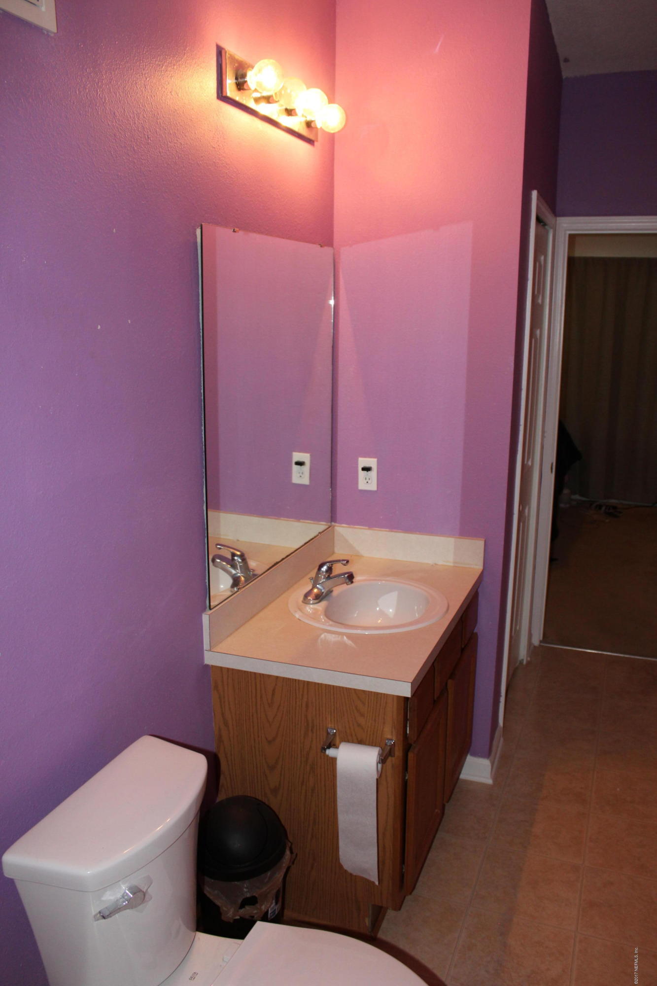 3680 Kirkpatrick Circle, Unit 5 Jacksonville, FL 32210 - Photo 9 of 18 a bathroom with a sink a toilet a mirror and vanity