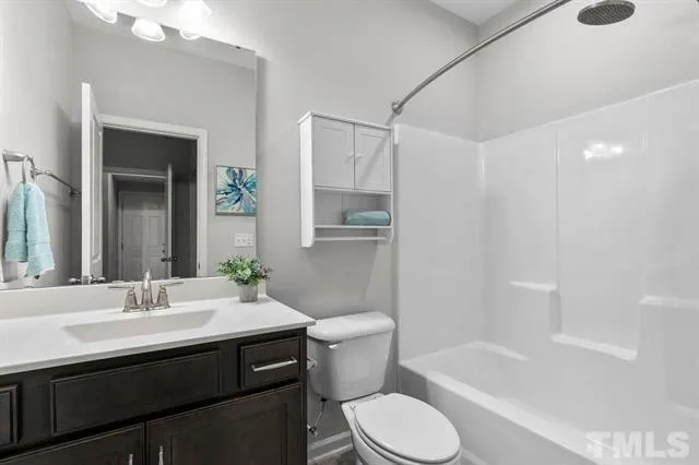 a bathroom with a sink a toilet and bathtub