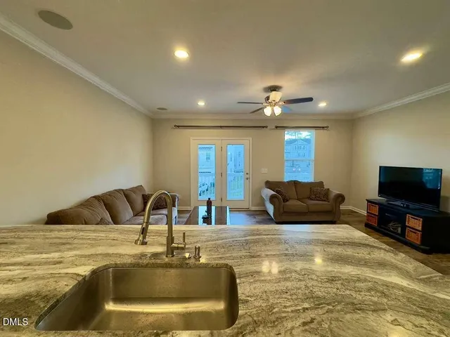 a kitchen with kitchen island a sink stainless steel appliances and window
