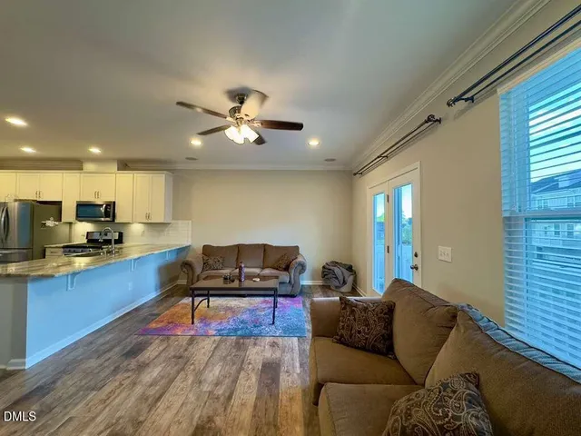 a living room with furniture and kitchen view
