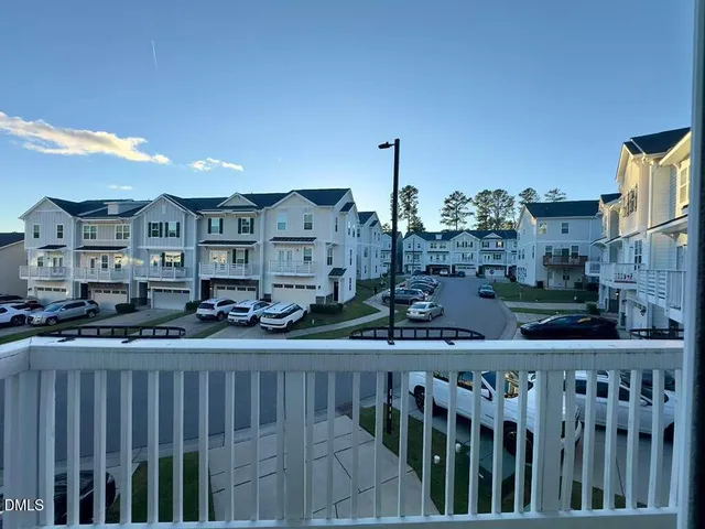a view of a balcony and car parked