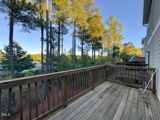 a view of balcony with wooden fence and floor