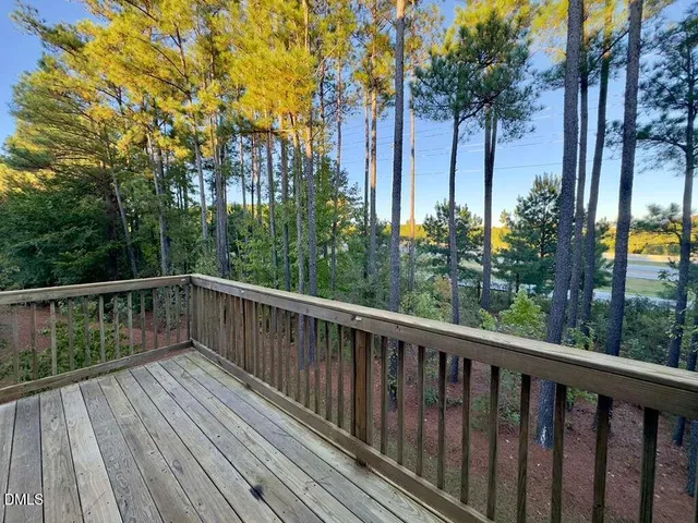 a view of balcony with wooden floor and gate