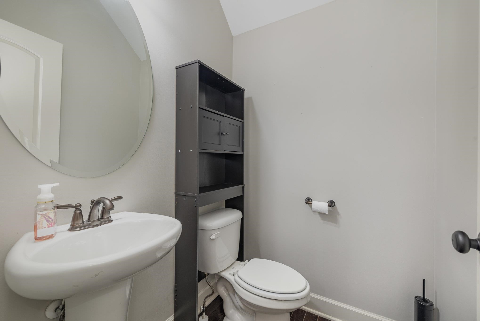 135 Pine Hawk Drive Spring Lake, NC 28390 - Photo 12 of 41 a white toilet sitting next to a bathroom sink
