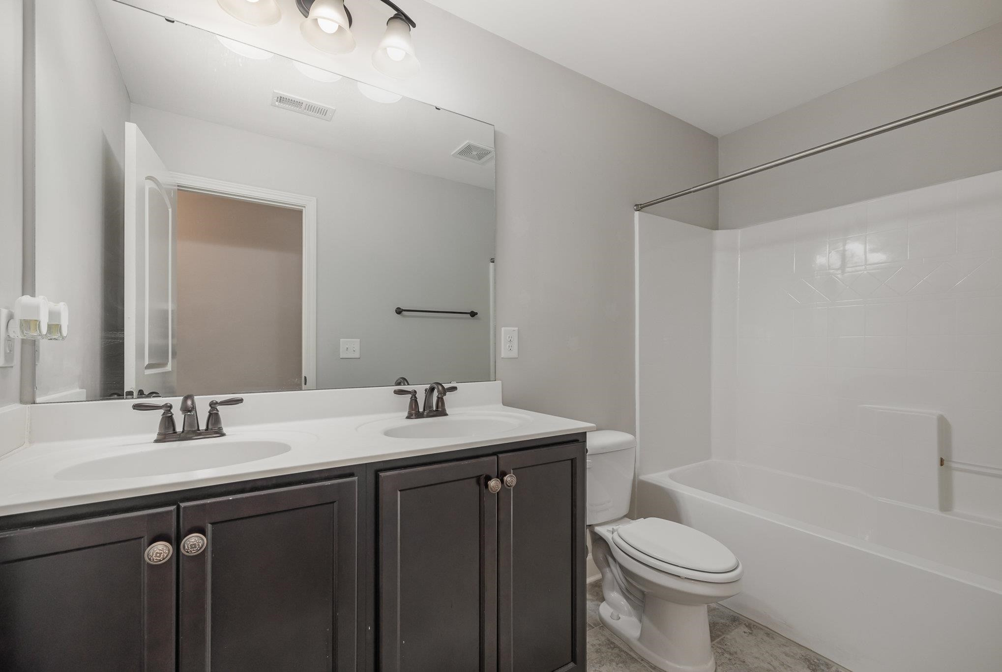 135 Pine Hawk Drive Spring Lake, NC 28390 - Photo 15 of 41 a bathroom with a sink toilet a mirror and shower