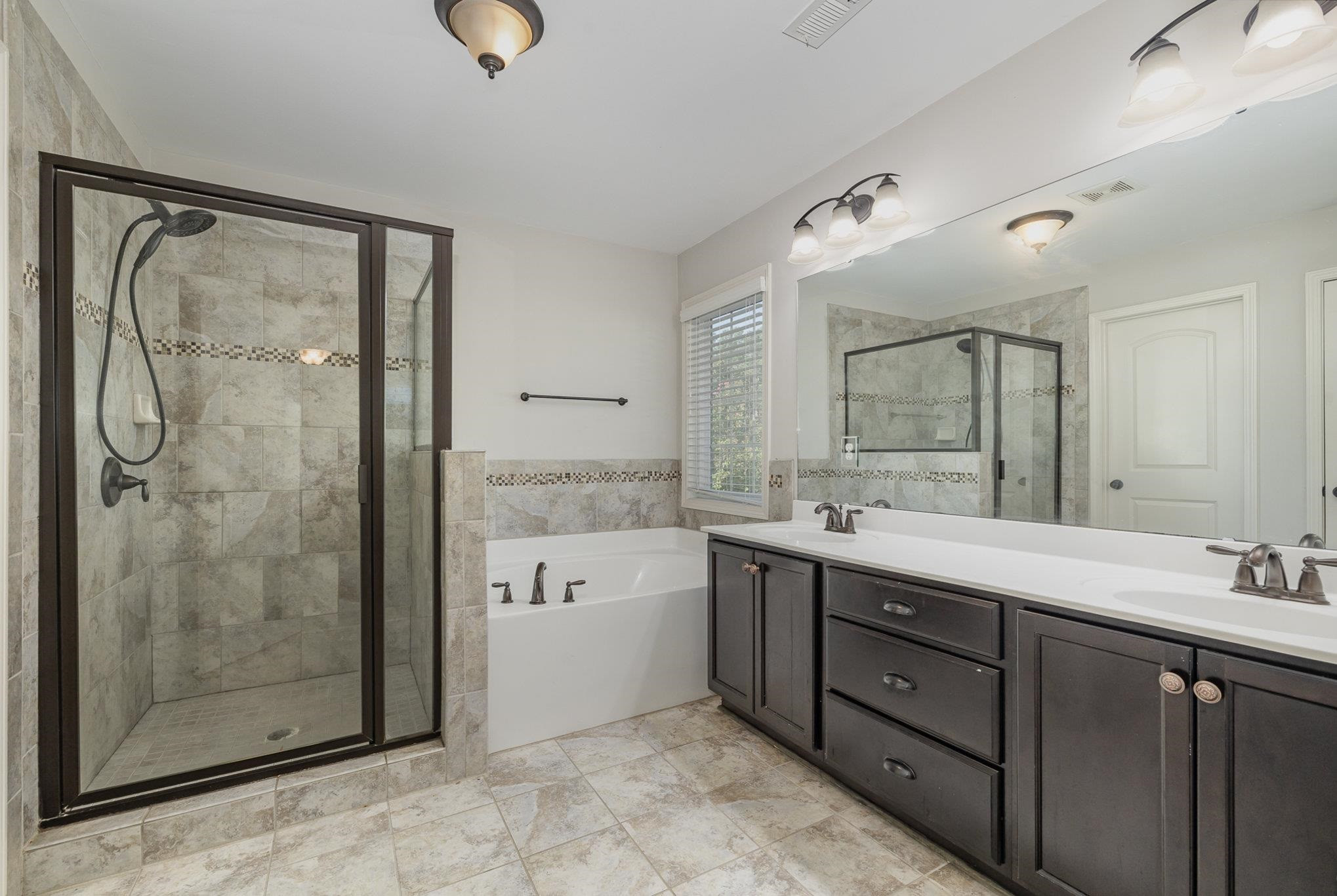 135 Pine Hawk Drive Spring Lake, NC 28390 - Photo 16 of 41 a bathroom with a granite countertop sink mirror and shower