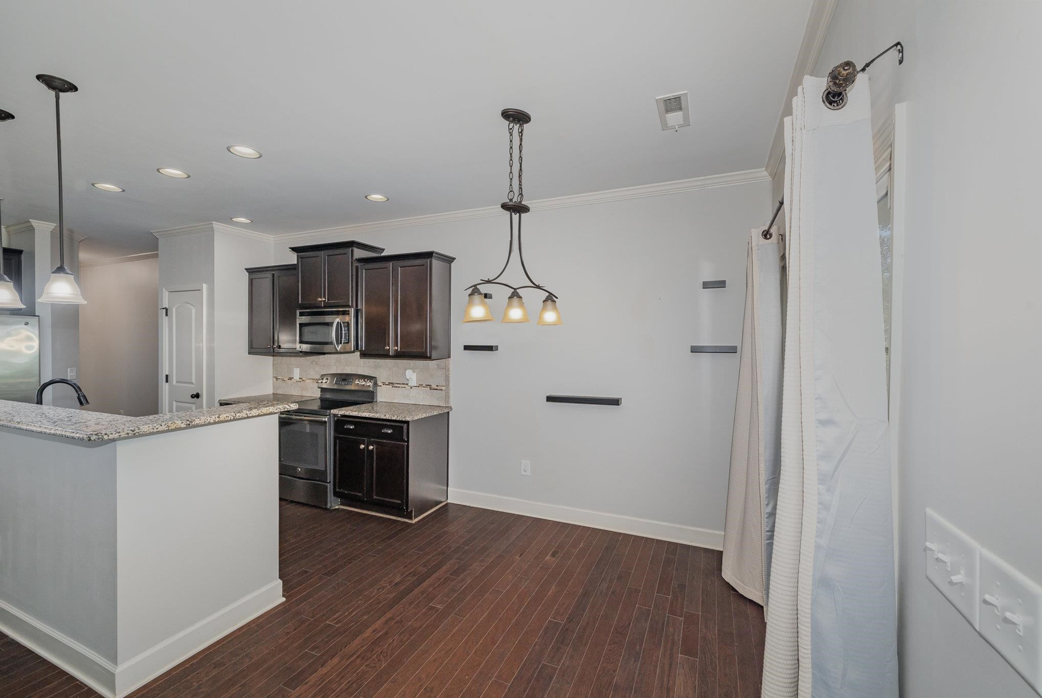 135 Pine Hawk Drive Spring Lake, NC 28390 - Photo 9 of 41 a kitchen with stainless steel appliances a refrigerator sink and stove top oven