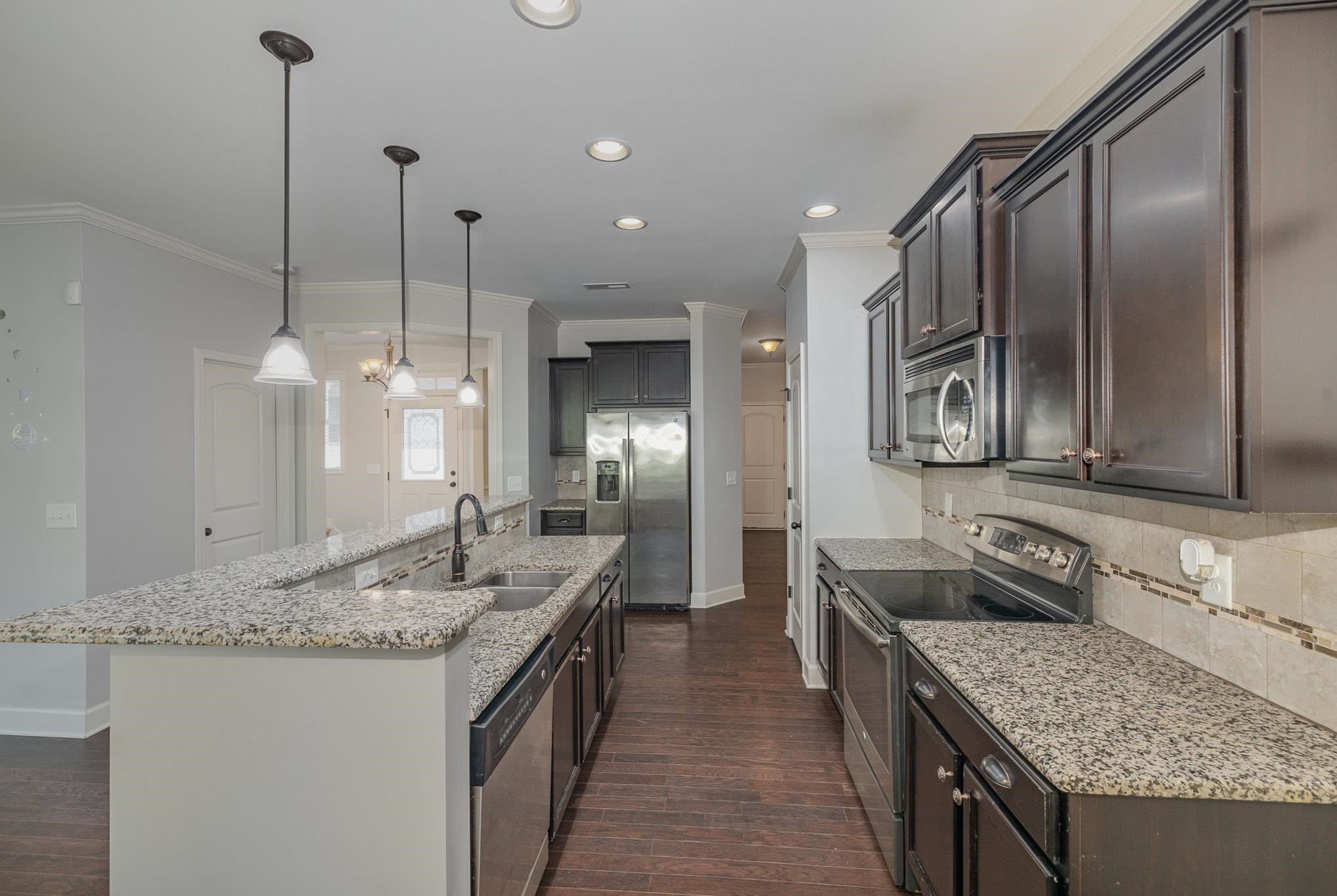 135 Pine Hawk Drive Spring Lake, NC 28390 - Photo 10 of 41 a bathroom with granite countertop a sink and a wooden floor