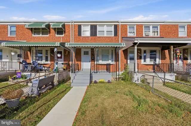 a front view of a multi story building with a yard