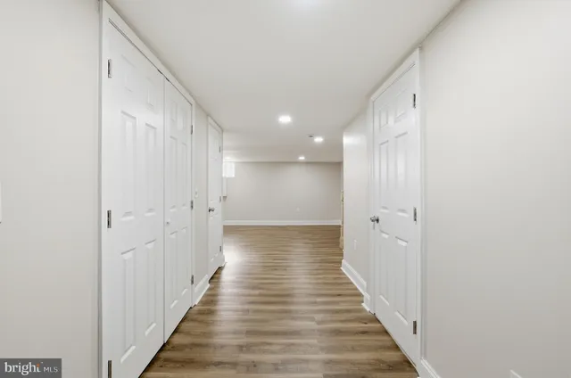 a view of a hallway with wooden floor