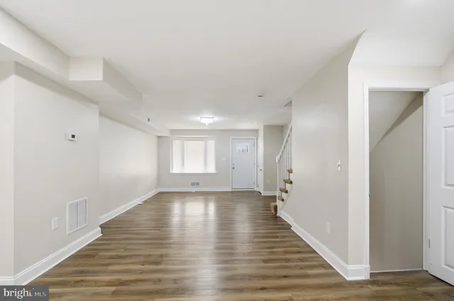 a view of a hallway with wooden floor