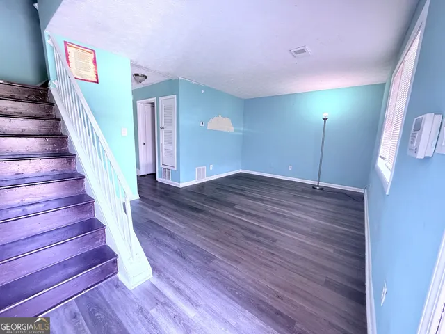 a view of an entryway with wooden floor