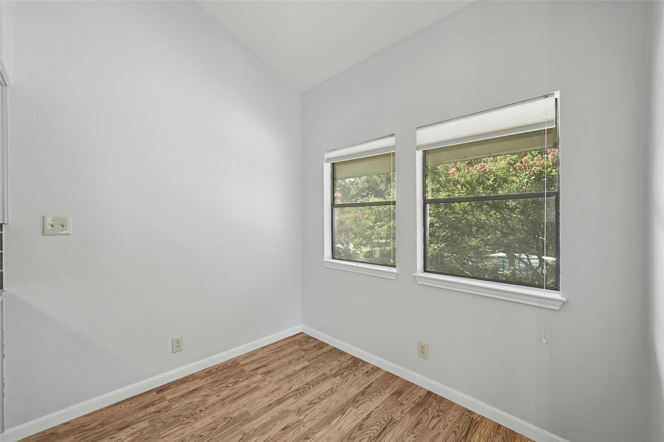 9226 Jollyville Road, Unit 221 Austin, TX 78759 - Photo 7 of 20 Well-lit room featuring durable wood flooring and ample natural light through multiple windows.